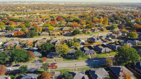 Suburban residential neighborhood detached houses with downtown Dallas in distance background,...