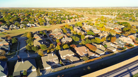 Upscale residential area with downtown Dallas in distance background, power pylons and precast...