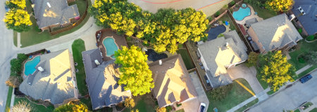Panorama aerial view suburban houses with swimming pools and colorful fall foliage in Coppell, suburbs Dallas, Texas, large detached single-family houses, fast growing real estate housing market. USAの写真素材