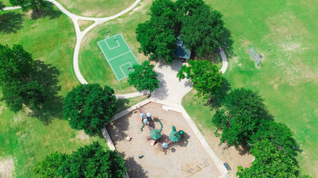 Baseball softball field with backstop netting, basketball courts, children playground equipment structure in upscale residential area West of Plano, Texas, swing, slide, woodchips ground, aerial. USAの写真素材