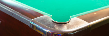 Panorama view chrome cast corners of classic pool tables at indoor game room in Houston, Texas,...