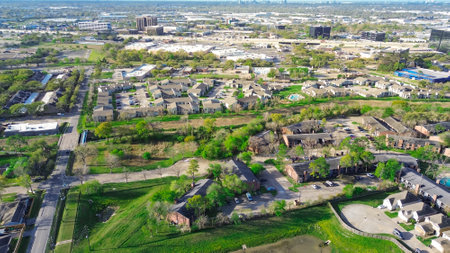 Busy Northwest Freeway US 290 in urbanization mixed use development area of residential house, new strata landed housing, retailer, warehouse, office building campus Fairbanks, Northwest Crossing. USAの写真素材