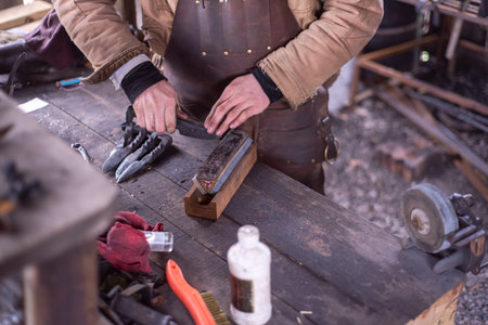 Cutting fluid, brush, grinder and whetstone to sharpens knife blade and edges of steel tools on iron...