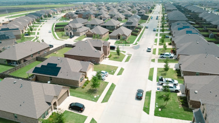 Peaceful residential street in new development area row of new construction houses solar roof in...
