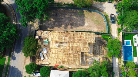 Vacant corner lot near under construction two story wooden timber framing mansion houses in wealthy...