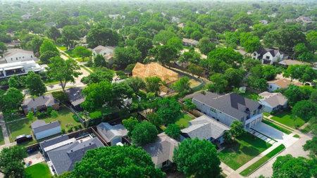 Lush greenery affluent neighborhood with luxurious homes, amenities, pools and two-story wooden timber framing mansion houses new construction in wealthy area along Walnut Hill in Dallas, aerial. USの写真素材