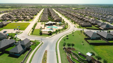 Proudly display of American flag pole at entrance of new construction homes area in Princeton, Collin County, Texas, community pool, shaded playground, recreational facilities, two-story houses. USAの写真素材