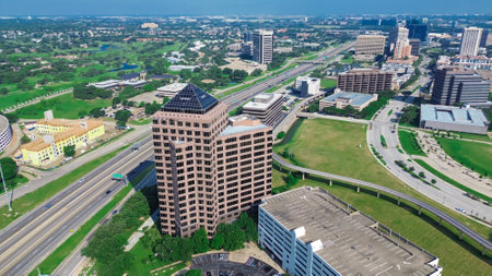 Fast growing business district along John Carpenter Freeway with elevated light rail, golf course, riverside leasing corporate campus multilevel parking, covered carport in Las Colinas, Irving. USAの写真素材