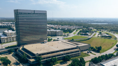 Riverside apartment complex, modern glass office building, multilevel parking, riverside leasing corporate campus in Las Colinas, Irving, suburbs Dallas Fort Worth workspace network commercial. USAの写真素材