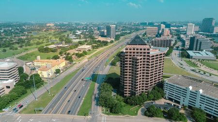 Fast growing Las Colinas downtown with new commercial property under construction, glass office building, high-rise towers, multilevel parking garage, golf course along John Carpenter Freeway. USAの写真素材