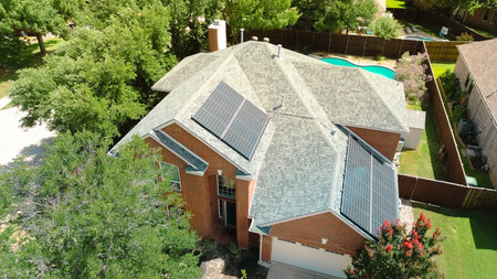 Suburban homes with rooftop solar panel arrays, angled installations for optimal sunlight capture, supporting clean efficiency energy, lower bills, sustainable living in DFW metroplex, Texas. USAの写真素材
