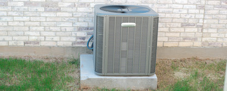 Panorama view outdoor HVAC unit and wall mounted electrical boxes installed along modern brick home, clean siding windows, grass landscaping shrub, privacy fence, disconnect switch, utility meter. USAの写真素材
