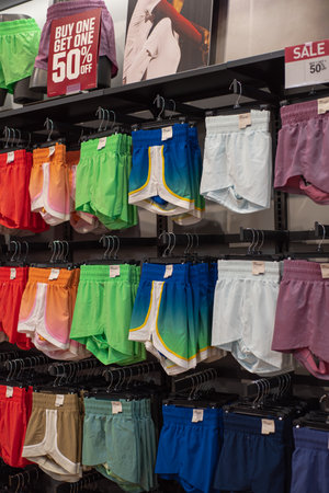 Side view dynamic retail scene highlights young female performance-driven athletic shorts designed for active youth lifestyles, stretchy, moisture-wicking fabric, bold color choices, sporty style. USAの写真素材