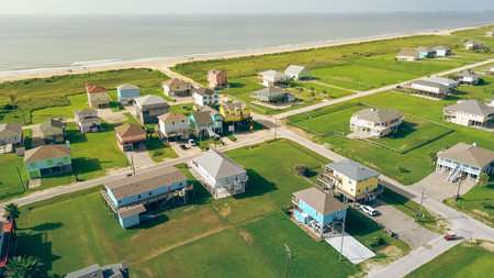 Elevated colorful beach house in oceanside neighborhood with road access to sandy shoreline. Ideal...