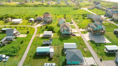 Concrete pad designed for large vehicle parking RVs, trailers along colorful coastal property. Raised beach house with spacious slab offers both accessibility and durability, Port Bolivar, Texas. USAの写真素材