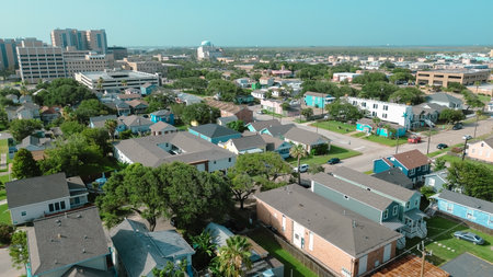 Drone view of Galveston highlights modern hospital towers and high-rises in the background....