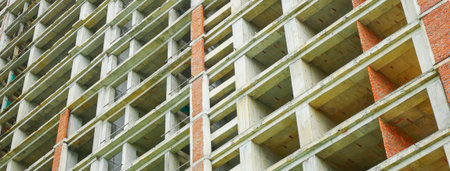 Panorama view concrete and brick structure with exposed floors, elevator shaft, skeletal framework...