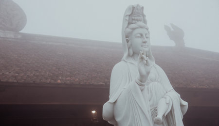 Panorama view Guanyin statue stands tall temple ornate roof, dragon sculpture. Intricate carvings,...