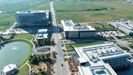 Lakeside amphitheater circular pond, rooftop HVAC office buildings, multilevel parking garage, restaurant patios, North Lake trails, large vacant land future development in Cypress Water, Dallas. USA