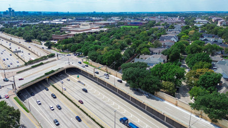 Large college campus with lush green courtyard, midtown Dallas skylines background from busy US 75...