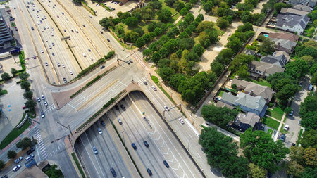 Overpass structure and dense traffic flows alongside busy US 75 corridor with University Park luxury...