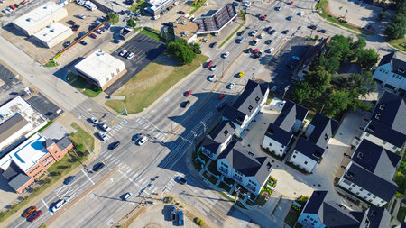 Flat-roof retail buildings and busy outdoor parking lot near Cooper, Abram and Main Street...