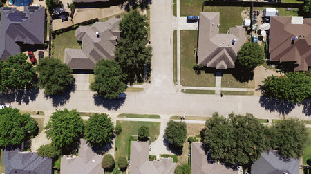 90-degree aerial view of North Richland Hills showing two-story homes, backyard pools, solar panels,...