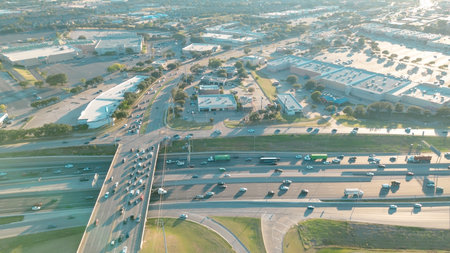 Peak-hour traffic along multilane highway in Lewisville, Texas with overpass and exit ramps,...