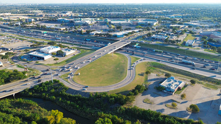 Mixed-use development in Lewisville, Texas with multilane highway, circular exit ramp, frontage...