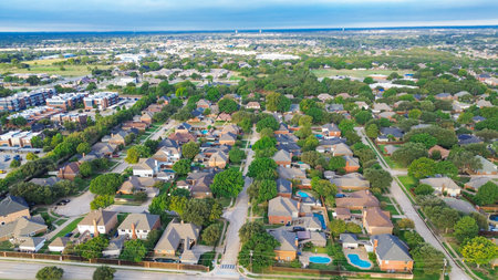 Suburban Highland Village, Texas featuring grid of single-family homes with backyard pools, adjacent...