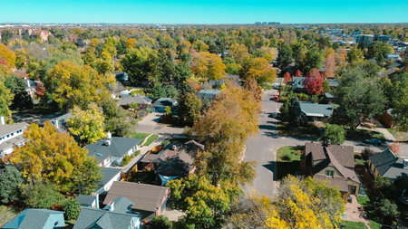Medical offices and college campus background from suburban homes with vibrant autumn trees in...