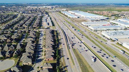 Light industrial zone large white warehouses and Castle Hills suburban neighborhood upscale homes....