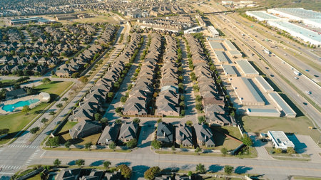 Community pool in upscale Castle Hills neighborhood row of uniform two-story homes. Immature...
