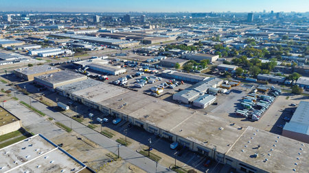 Warehouse buildings with covered loading docks and backed-in trailers. These freight terminals show active goods movement, tailored for high-volume loading, unloading, dispatch in Dallas, Texas. USAの写真素材