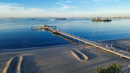 Pier and twin islands view from Belmont Veterans Memorial Pier faces harbor channel with Island Chaffee and Island Freeman visible offshore. Calm water, warm coastal haze, Long Beach, California. USAの写真素材