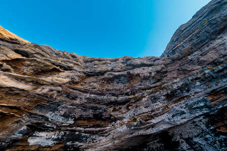 a rock with many holes eroded by the sea wavesの写真素材
