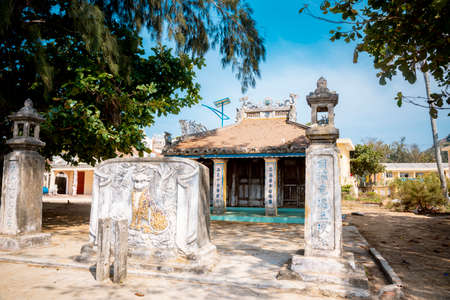 Ancient temple at Ly Son, with tiled roof and mossy wallsのeditorial素材