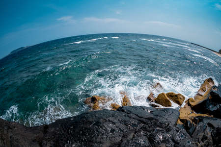 Beautiful seascape with waves crashing against the rocky shore.