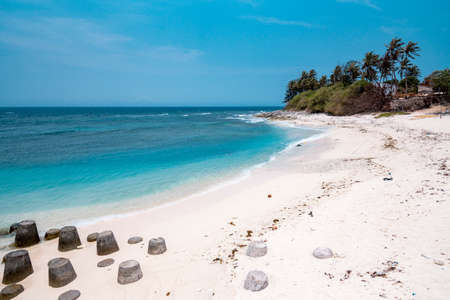Tropical beach with clear turquoise water and rocks