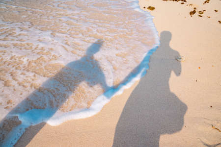 Shadow of the bride and groom on the beach. Wedding concept.の写真素材