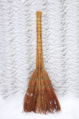 Handmade straw broom on the snowの写真素材