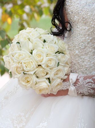 Wedding bouquet of roses in hands of the brideの写真素材