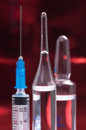Disposable syringes and ampules on a colored backgroundの写真素材