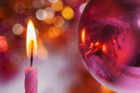 A candle on the background of Christmas decorationsの写真素材