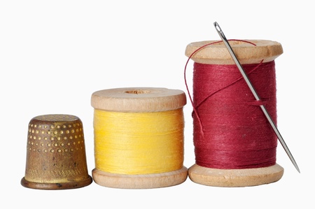 Old thimble and needle with thread isolatedの写真素材