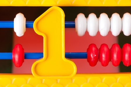 Plastic yellow number one on the background of children