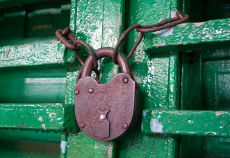 Old rusty lock on a wooden door close upの写真素材