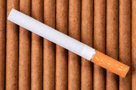 Cigarette with brown filter on dark cigarettes close upの写真素材