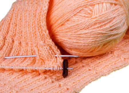 Homemade knitting of pink yarn on white isolated