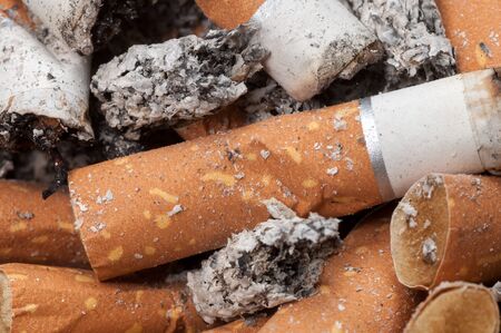 Cigarette butts and ashes close upの写真素材